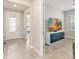 Bright entryway featuring wood-look tile flooring and views into the living room with lots of light at 2496 Pine Preserve Ct, St Cloud, FL 34771