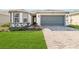 Charming single-story home with a two-car garage, well-maintained lawn, and beautiful brick driveway at 2496 Pine Preserve Ct, St Cloud, FL 34771