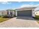 Charming single-story home with a two-car garage, well-maintained lawn, and beautiful brick driveway at 2496 Pine Preserve Ct, St Cloud, FL 34771