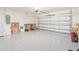 Spacious two-car garage featuring a speckled floor, and white walls at 2496 Pine Preserve Ct, St Cloud, FL 34771