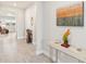 Hallway with decor on a console table and views into the living space with wood-look tile flooring at 2496 Pine Preserve Ct, St Cloud, FL 34771