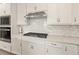 Modern kitchen featuring stainless steel appliances and white backsplash at 2496 Pine Preserve Ct, St Cloud, FL 34771