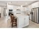 Kitchen featuring stainless steel appliances, white backsplash, and island with bar seating at 2496 Pine Preserve Ct, St Cloud, FL 34771