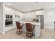 Bright kitchen with white cabinets, stainless steel appliances, and island with bar seating at 2496 Pine Preserve Ct, St Cloud, FL 34771