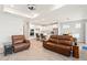 Living room with wood-look tile flooring and open concept into the white kitchen at 2496 Pine Preserve Ct, St Cloud, FL 34771