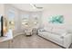 Bright living room with large windows, neutral walls, and modern decor at 2496 Pine Preserve Ct, St Cloud, FL 34771