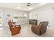 Bright living room with modern lighting, wood-look tile floors, and comfortable leather seating at 2496 Pine Preserve Ct, St Cloud, FL 34771