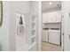 Cozy mud room featuring a bench with storage, and a laundry room with white cabinets and machines at 2496 Pine Preserve Ct, St Cloud, FL 34771