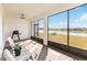 Outdoor patio featuring a ceiling fan, white furniture, and views of the lake at 2496 Pine Preserve Ct, St Cloud, FL 34771