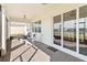 Screened patio featuring brick flooring, white furniture, and views of the lake at 2496 Pine Preserve Ct, St Cloud, FL 34771