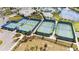 Well-maintained community tennis courts surrounded by lush landscaping and palm trees at 2496 Pine Preserve Ct, St Cloud, FL 34771