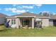 Well-manicured backyard featuring a patio, hot tub, and ample lawn space at 253 Golden Sands Cir, Davenport, FL 33837