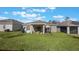 Spacious backyard with a patio, hot tub, and ample green space for outdoor activities and relaxation at 253 Golden Sands Cir, Davenport, FL 33837