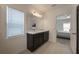 Bright bathroom with double vanity, white countertops, tile flooring, and bedroom view at 253 Golden Sands Cir, Davenport, FL 33837