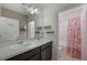 Bathroom with double sink vanity and a shower and tub combo with a floral shower curtain at 253 Golden Sands Cir, Davenport, FL 33837