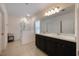 Bathroom features dual sinks, large mirror, and glass-enclosed shower at 253 Golden Sands Cir, Davenport, FL 33837