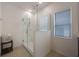 Bathroom features a modern glass shower and a bright window at 253 Golden Sands Cir, Davenport, FL 33837