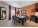 Traditional dining room features a wood table with seating, complementary mirror, and access to the kitchen at 253 Golden Sands Cir, Davenport, FL 33837