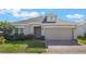 Charming single-story home featuring a brick driveway and well-maintained landscaping at 253 Golden Sands Cir, Davenport, FL 33837