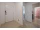 Clean foyer entry with tile floor, white walls, and doorways to the bathroom and other rooms at 253 Golden Sands Cir, Davenport, FL 33837