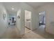 Bright hallway with carpeted floor leading to the living room, laundry closet, and bedroom at 253 Golden Sands Cir, Davenport, FL 33837