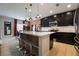 Kitchen with island and bar stool seating with stainless steel appliances and dark cabinets at 253 Golden Sands Cir, Davenport, FL 33837