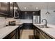 Modern kitchen featuring dark cabinets, stainless steel appliances, and light countertops at 253 Golden Sands Cir, Davenport, FL 33837