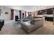 Open concept living room with a large sectional couch and an adjacent modern kitchen at 253 Golden Sands Cir, Davenport, FL 33837