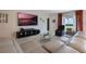 Comfortable living room with modern furnishings, large TV, and view of the outdoor patio at 253 Golden Sands Cir, Davenport, FL 33837