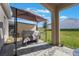 Covered patio with a grill and outdoor seating area, perfect for entertaining guests and enjoying outdoor meals at 253 Golden Sands Cir, Davenport, FL 33837