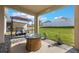 Backyard with a covered patio, grill, fire pit, and green grass at 253 Golden Sands Cir, Davenport, FL 33837