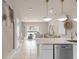 Open concept kitchen with island and views to living area at 2582 Winsome Way, Davenport, FL 33896