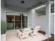 Private patio with two white chairs, perfect for relaxing at 2582 Winsome Way, Davenport, FL 33896