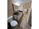 Bathroom with granite countertop and tiled floor at 3501 S Atlantic Ave # 6060, New Smyrna Beach, FL 32169