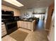 Kitchen with breakfast bar and view into living room at 3501 S Atlantic Ave # 6060, New Smyrna Beach, FL 32169