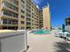 Community pool with surrounding patio furniture at 3501 S Atlantic Ave # 6060, New Smyrna Beach, FL 32169