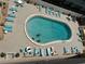 Inviting community pool with surrounding lounge chairs at 3501 S Atlantic Ave # 6060, New Smyrna Beach, FL 32169