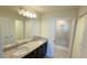 Bathroom with granite countertop, double sinks, and shower at 4114 Lana Ave, Davenport, FL 33897