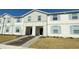 Two-story townhome with light-colored siding, and a landscaped front yard at 4114 Lana Ave, Davenport, FL 33897