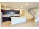 Modern kitchen with dark cabinets, granite counters, and island at 4114 Lana Ave, Davenport, FL 33897