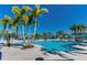 Community resort pool with palm trees and lounge chairs at 4114 Lana Ave, Davenport, FL 33897