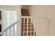 Interior photo of a carpeted staircase with white railings at 4114 Lana Ave, Davenport, FL 33897