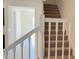 Interior photo of a carpeted staircase with white railings at 4114 Lana Ave, Davenport, FL 33897