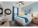 Bedroom with a king-size bed, accent wall, and stylish decor at 4285 Prologue Way, Kissimmee, FL 34746