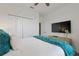 Bedroom with king-size bed and teal throw blanket at 4285 Prologue Way, Kissimmee, FL 34746