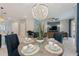 Bright dining room with a round table and blue chairs at 4285 Prologue Way, Kissimmee, FL 34746