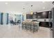 Modern kitchen with dark cabinets, island, and breakfast bar at 4285 Prologue Way, Kissimmee, FL 34746