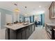 Modern kitchen with large island and white quartz countertops at 4285 Prologue Way, Kissimmee, FL 34746