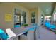 Outdoor patio with dining table and lounge chairs at 4285 Prologue Way, Kissimmee, FL 34746