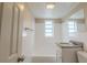 Bright bathroom featuring a white tiled shower/tub and a granite vanity at 451 Rogers St, Orlando, FL 32811